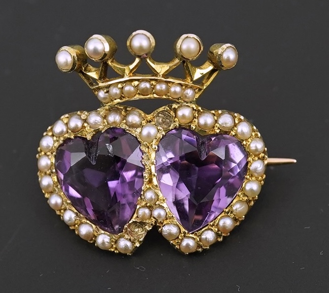 A late Victorian 9ct gold, two stone heart shaped amethyst and seed pearl cluster set coronet brooch